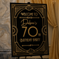 Decorative sign for a 70th birthday party on an easel with elegant background