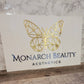 White and gold acrylic sign for Monarch beauty