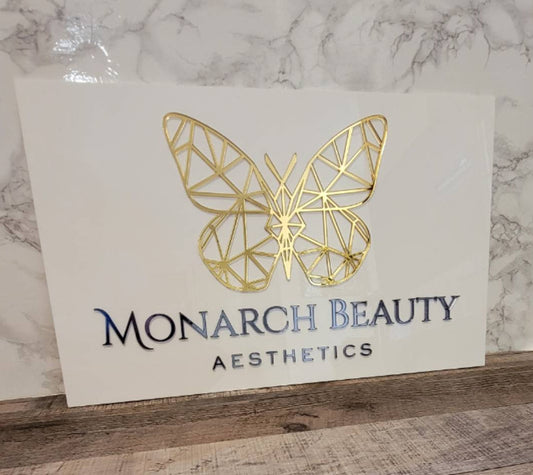 White and gold acrylic sign for Monarch beauty